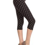High Waisted Capri Leggings With An Elastic Band In A White Polka Dot Print Over A Black Background
